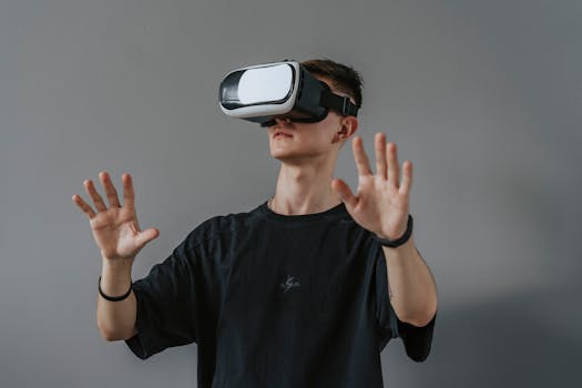 Young man explores virtual reality with VR headset, hands raised.