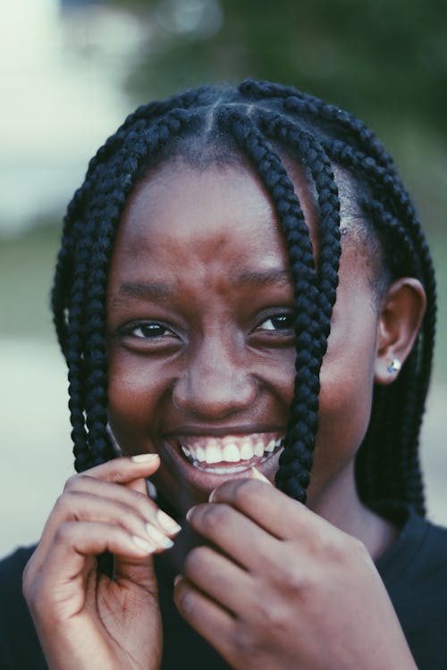 Cheerful black woman with braids