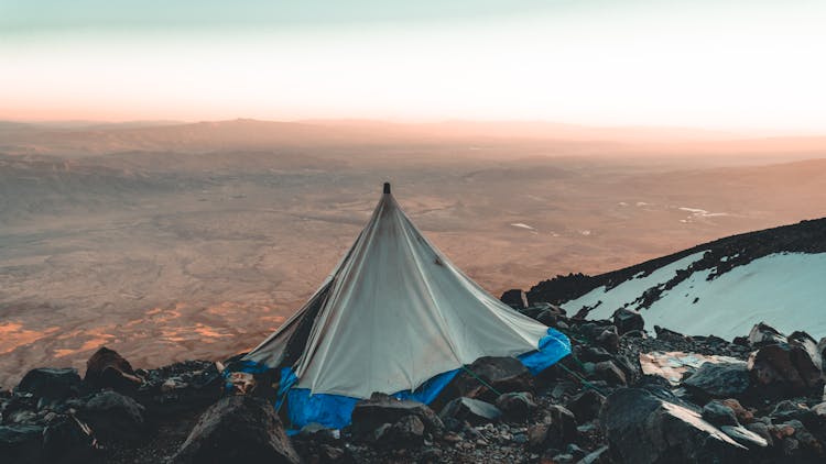 Gray Tent On Mountain Top Wit Snow