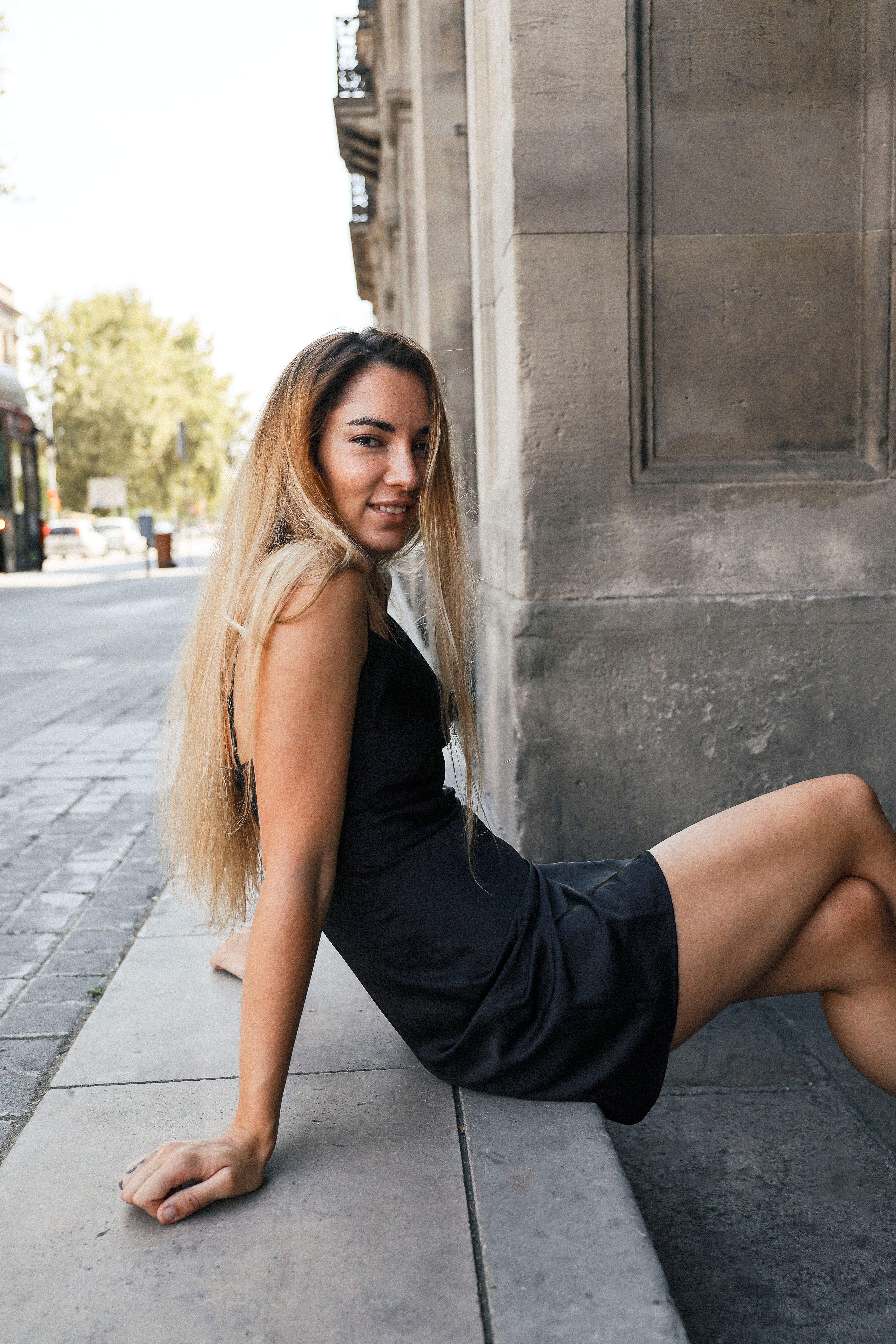 Woman in Black Dress on Concrete Stairs · Free Stock Photo