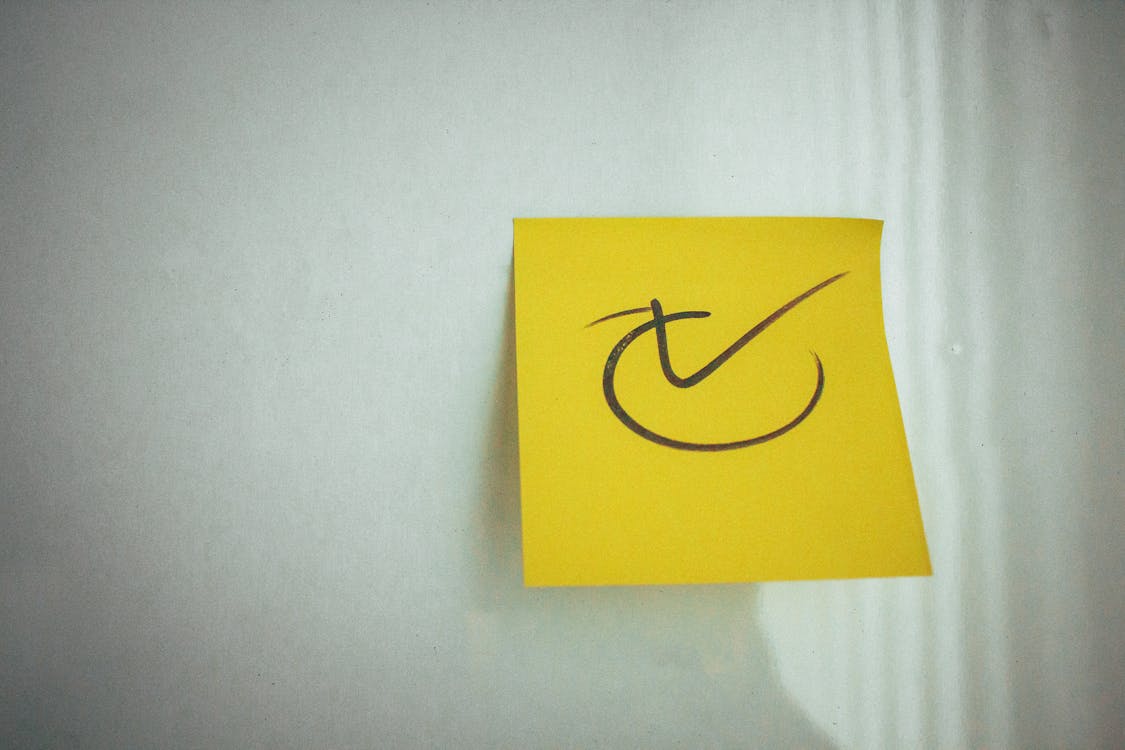 Free Yellow Sticky Note on a White Surface Stock Photo