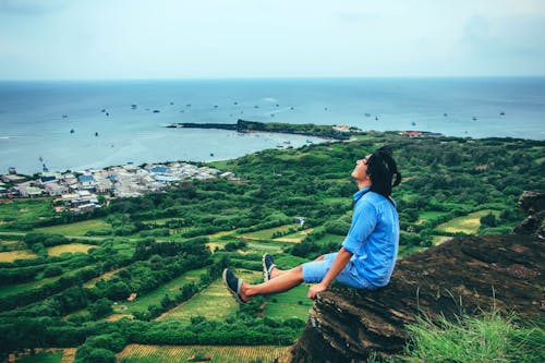 Man Sitting on Cliff