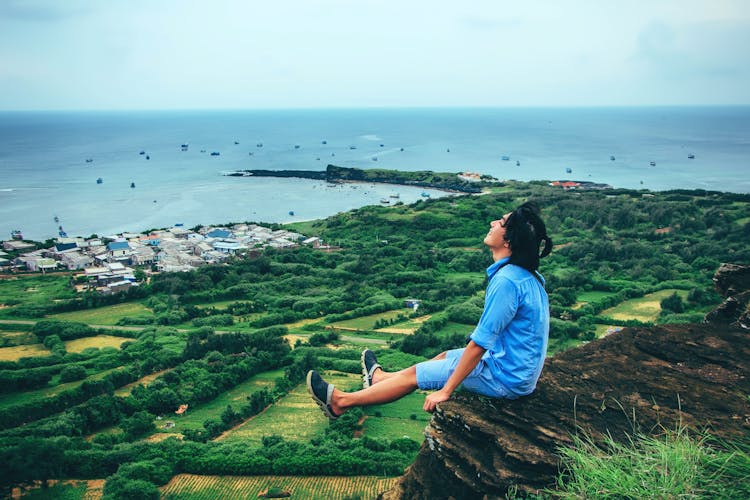 Man Sitting On Cliff