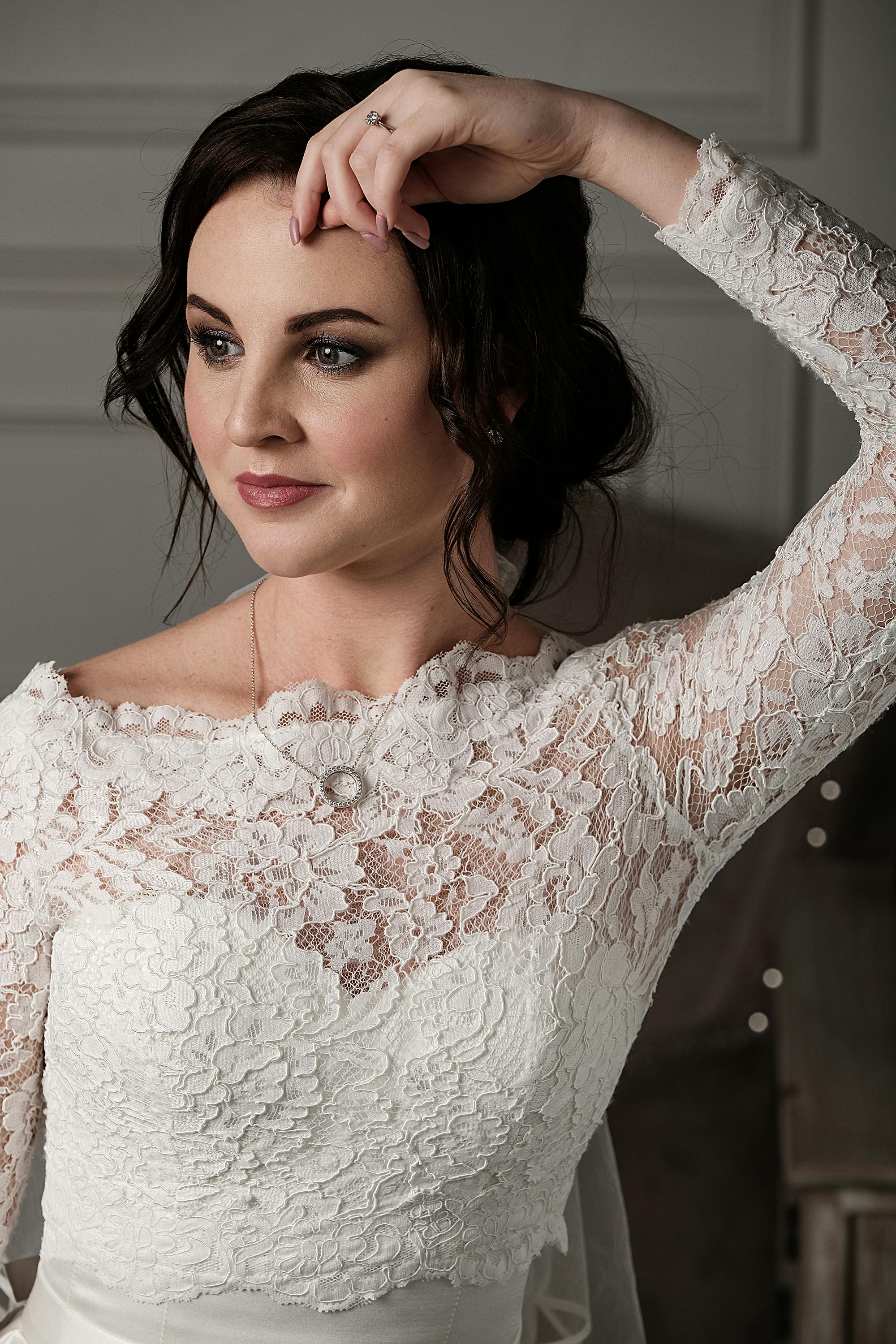 happy bride in lace white dress in studio