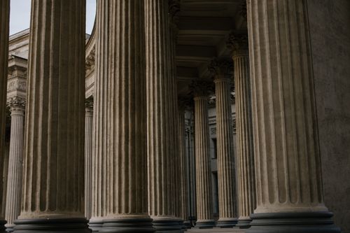 Free Ornate stone columns in a historic building showcasing classical architecture. Stock Photo