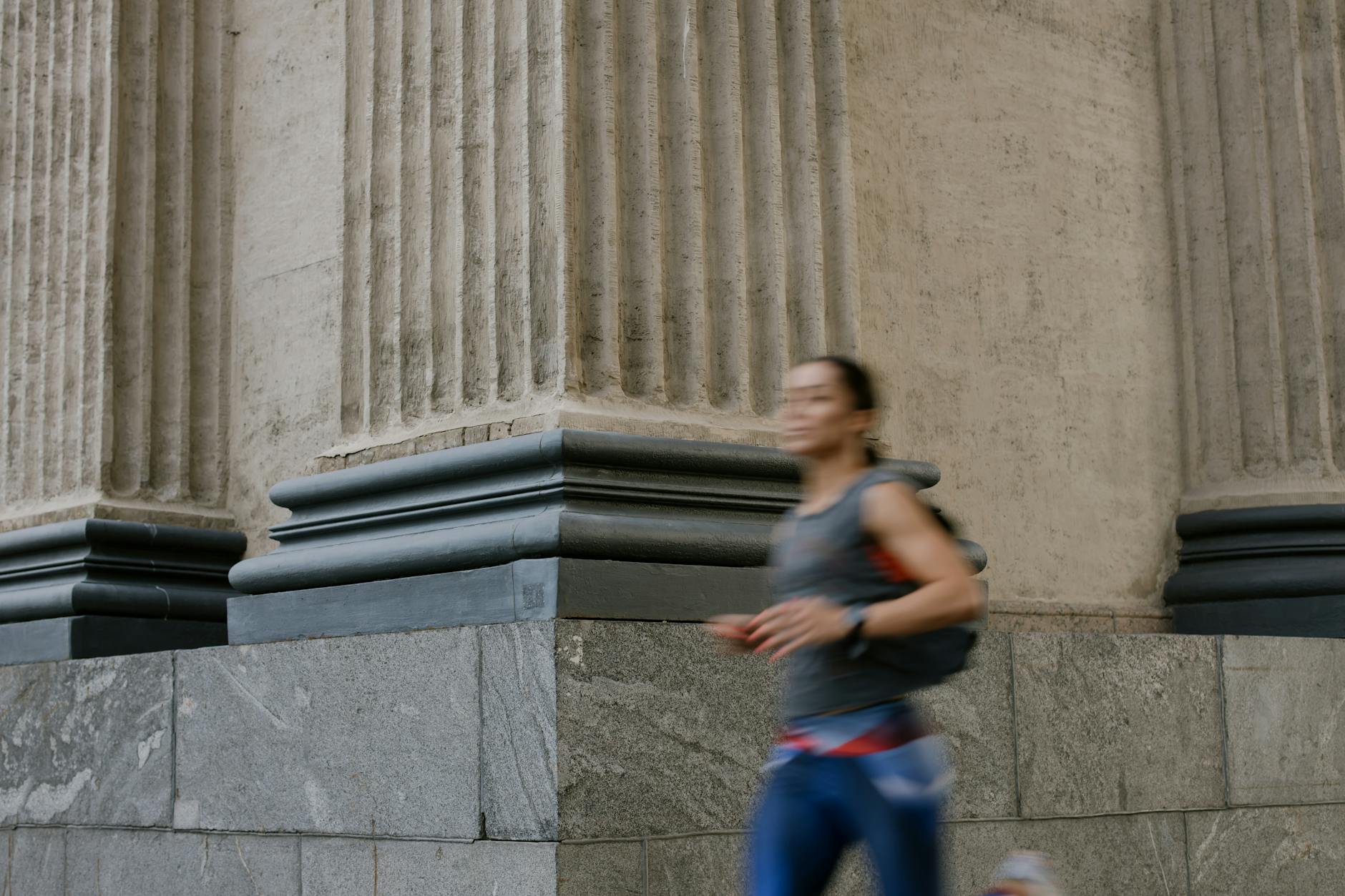 A Woman in a Tank Top Jogging