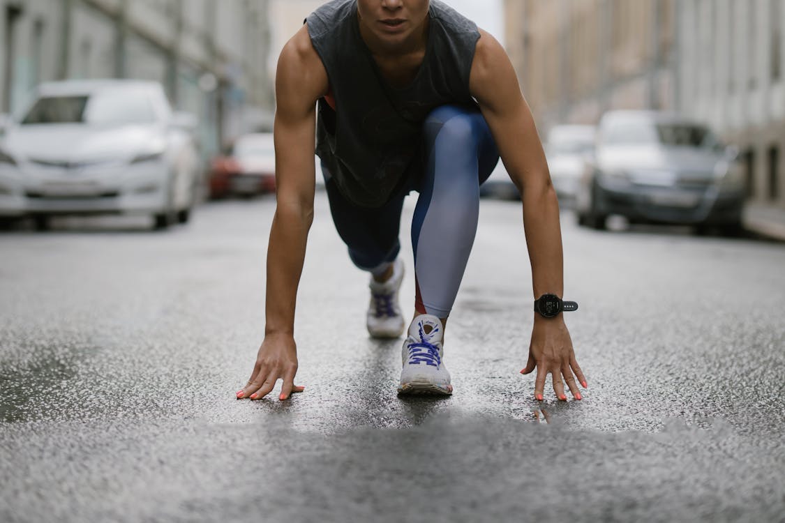 Woman in Black Tank Top and Blue Leggings Doing Yoga