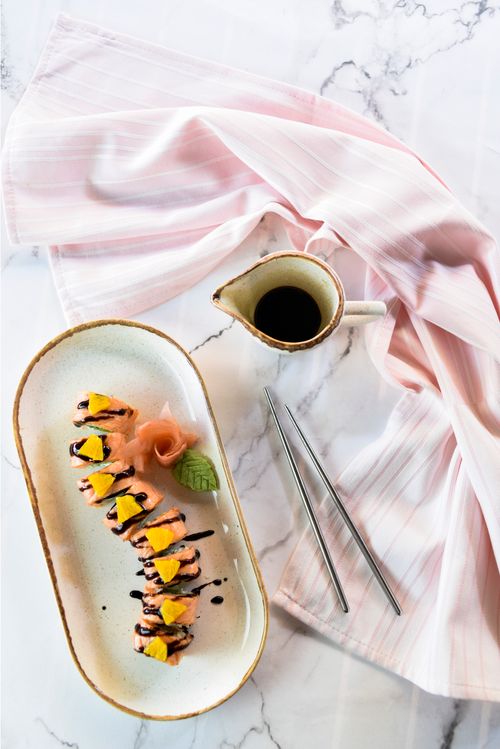 Free Top view of delicious sushi rolls with wasabi, ginger, and soy sauce on a marble tabletop. Stock Photo