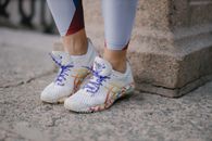 Person in White Blue and Red Nike Sneakers