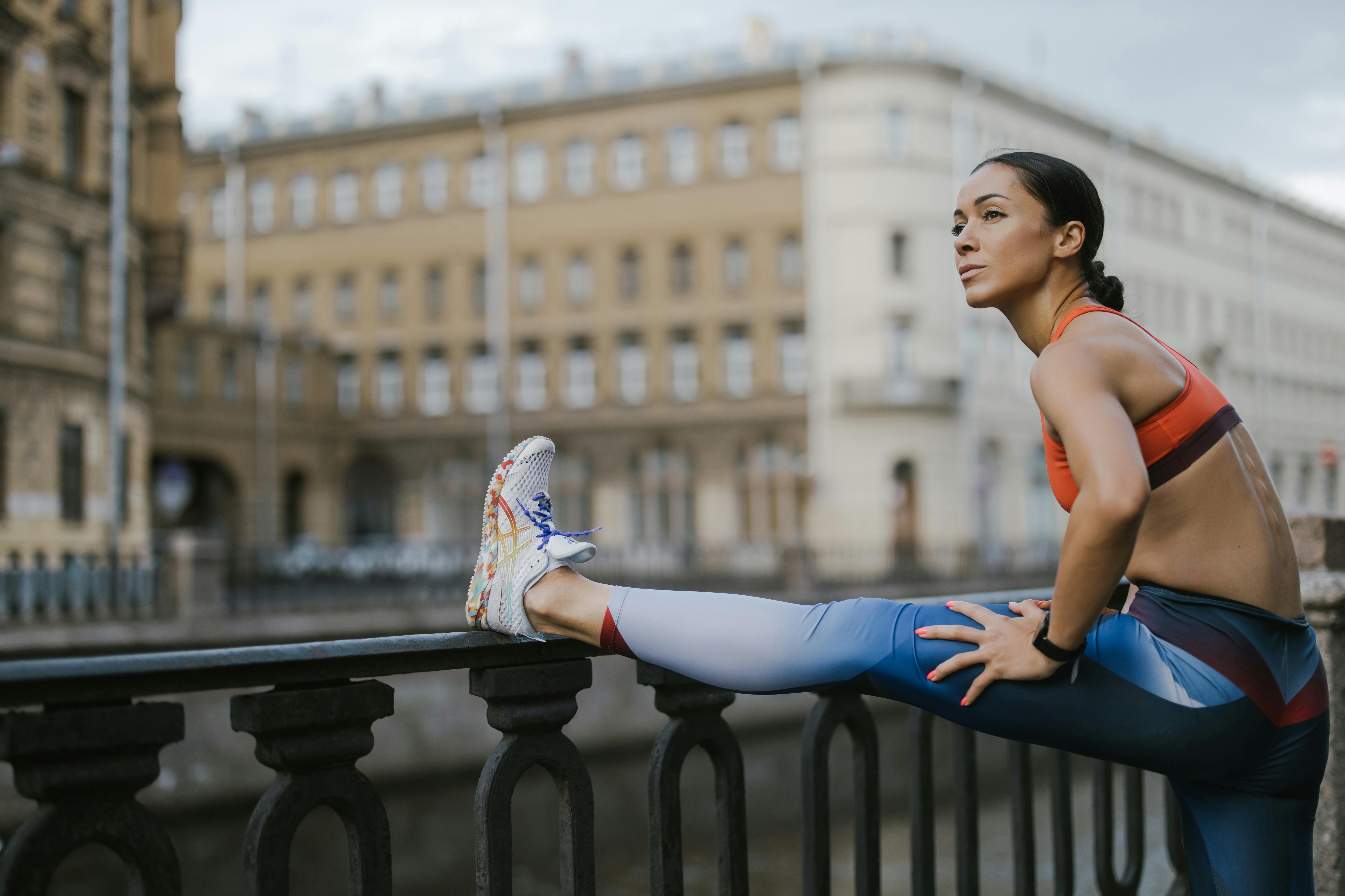 a woman stretching her legs on the railing