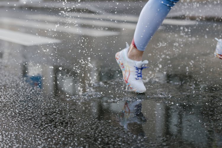 A Person Running On Wet Road