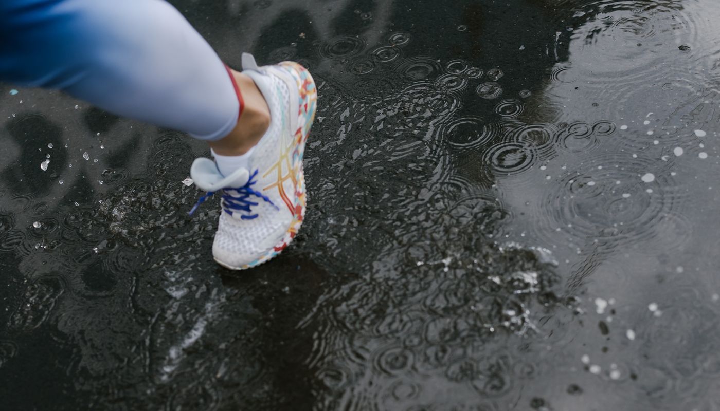 100 day challenge — A Person Wearing a White Shoes while Stepping on Wet Road · Free. Photo: Pexels