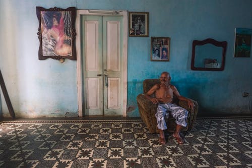 Elderly man sitting in armchair