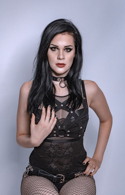 Free Model in gothic attire posing in a studio with minimalist decor, showcasing edgy fashion. Stock Photo