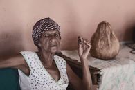 Old black woman smoking cheroot