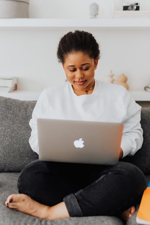 Free A Woman Using Her Laptop at Home Stock Photo