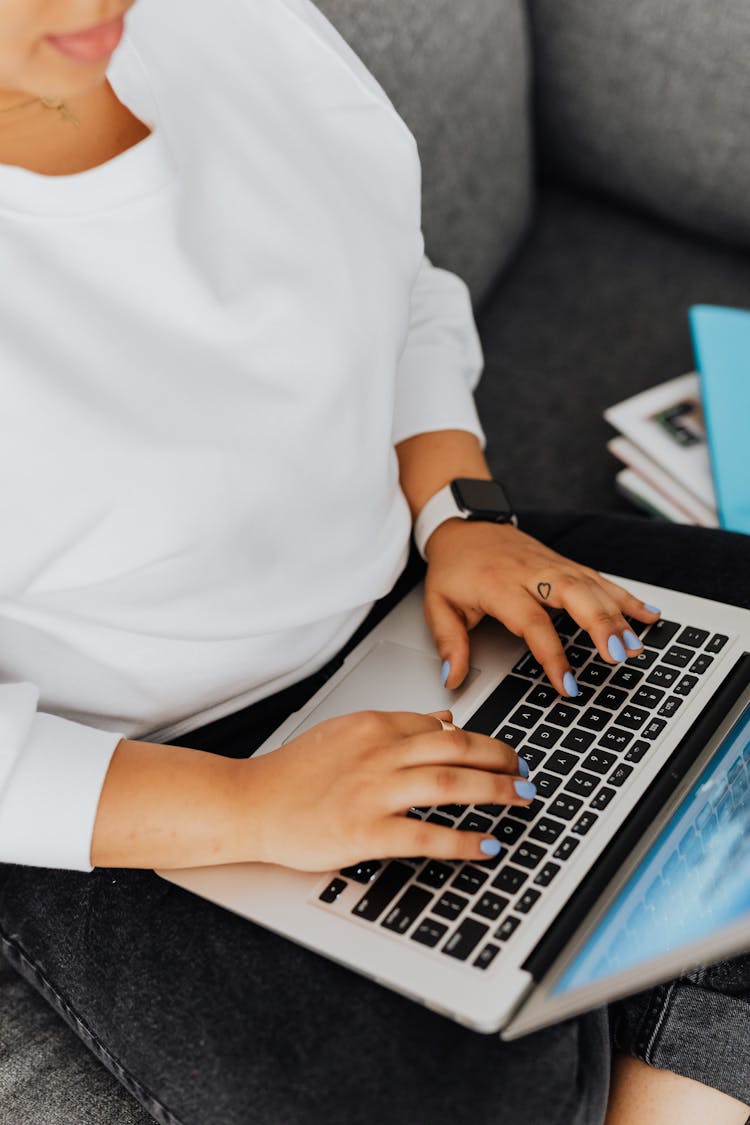 Close-Up Shot Of A Person Using A Laptop