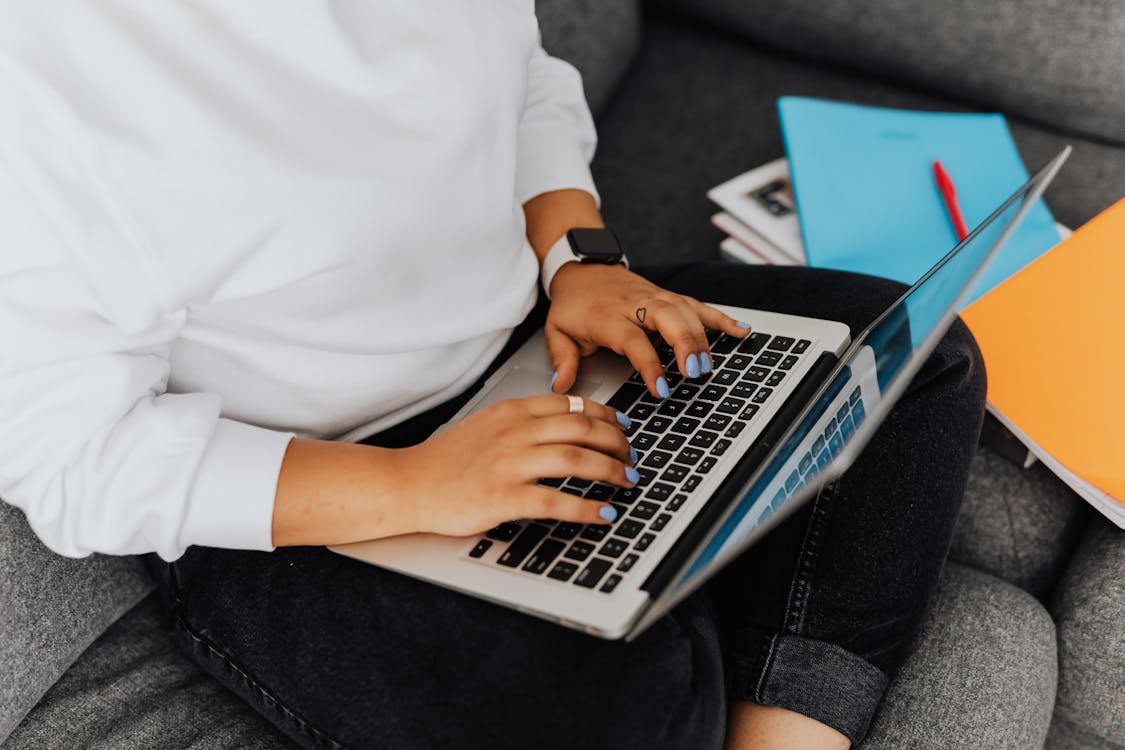 Free Close-Up Shot of a Person Using a Laptop Stock Photo