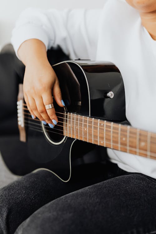 Free Close-Up Shot of a Person Playing an Acoustic Guitar Stock Photo