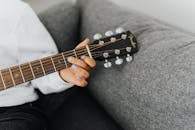 Person Holding Brown Acoustic Guitar