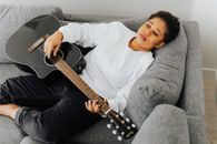 Man in White Shirt Playing Guitar