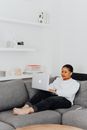 Woman Using Laptop in Living Room