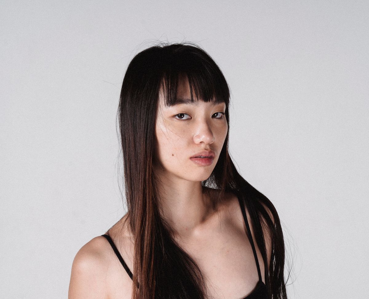 Young woman with long straight hair and Korean see-through wispy bangs — wispy bangs hairstyles