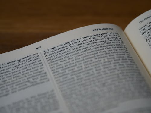 Free An Open Bible on a Wooden Surface Stock Photo