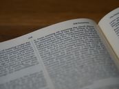 White Book Page on Brown Wooden Table