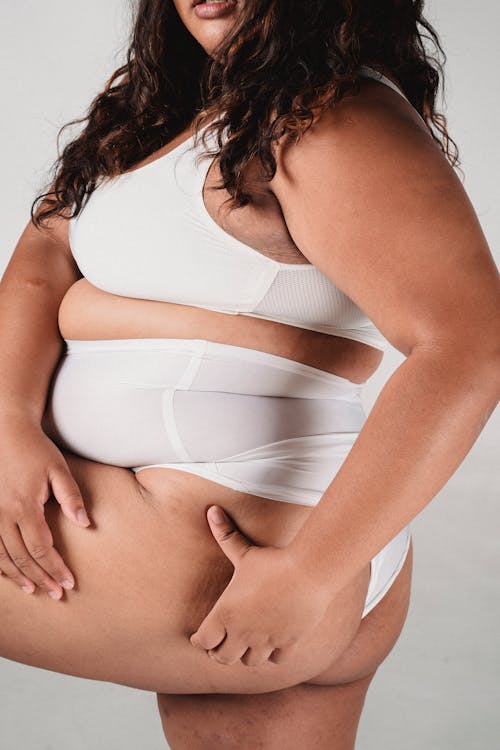 Free Overweight woman in underwear touching buttocks Stock Photo