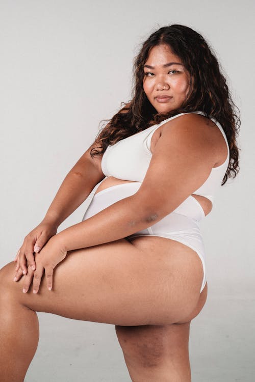Plus size Asian model in underwear looking at camera