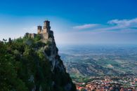 Spectacular view of the historic San Marino castle perched on a majestic cliff overlooking the valley.
