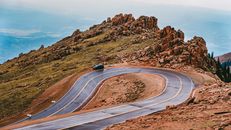 Blue Car on Road Near Brown Rock Formation