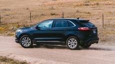 Blue Suv on Brown Field