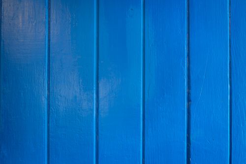 Free Close-up of a vibrant blue wooden wall with vertical planks and a textured surface. Stock Photo