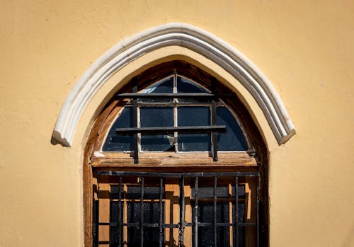 Free Symmetrical Photo of a Window on a Yellow Wall Stock Photo