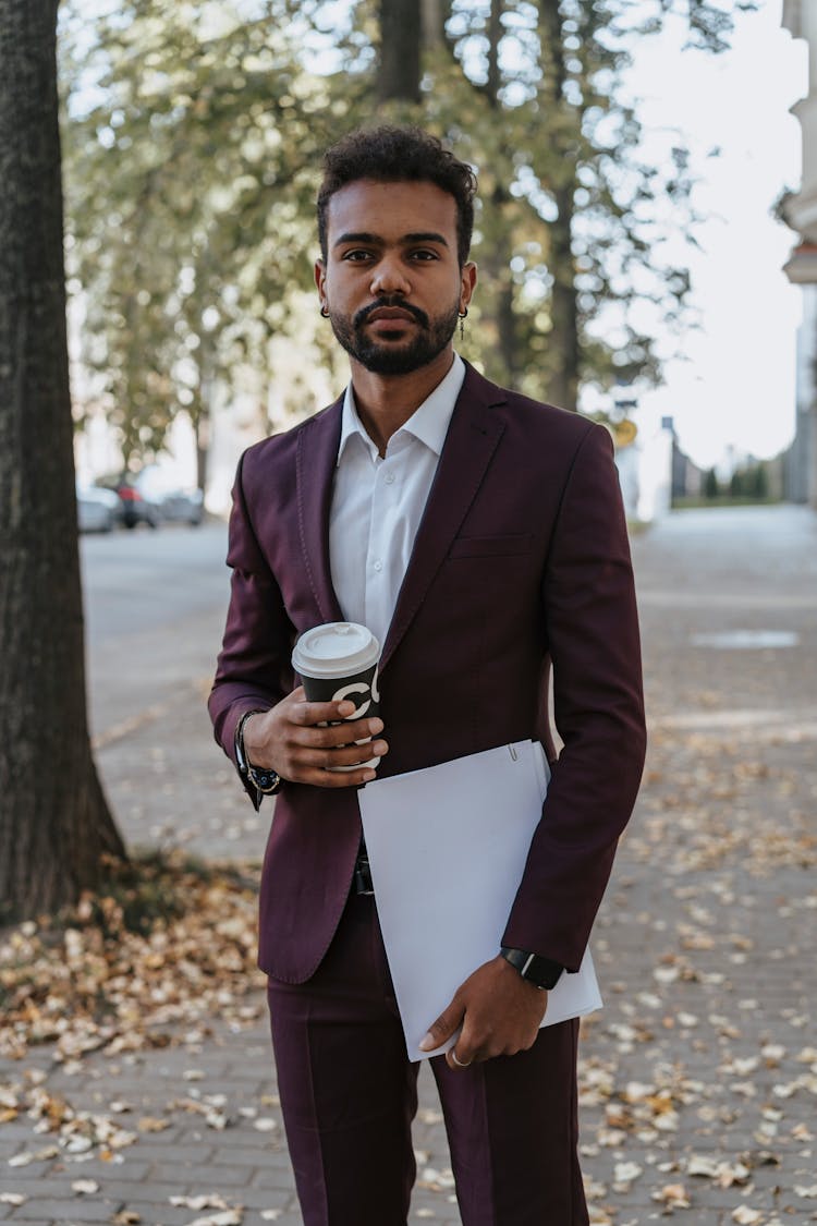 A Bearded Man Holding A Coffee