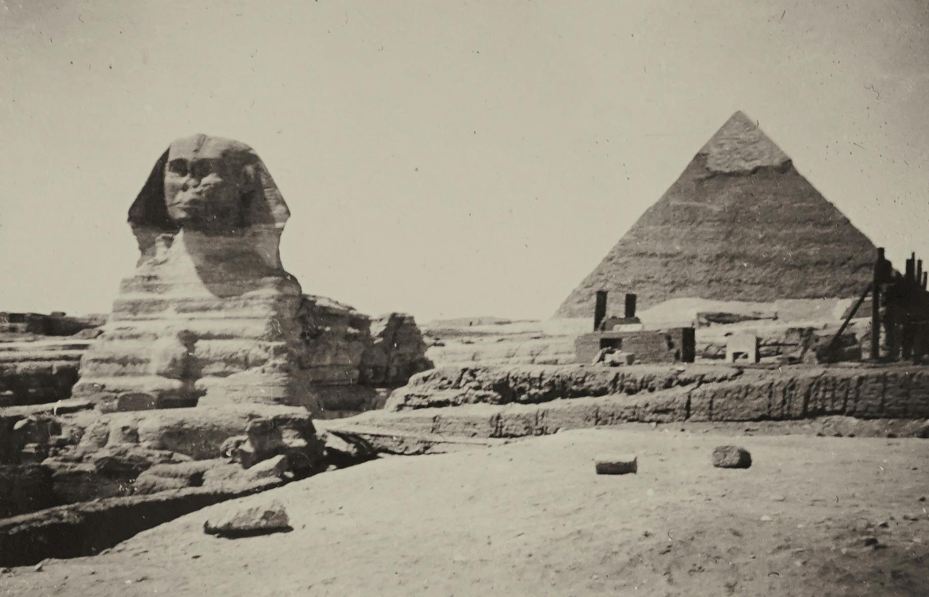 Classic black and white image capturing the Sphinx and Pyramid of Giza, Egypt.