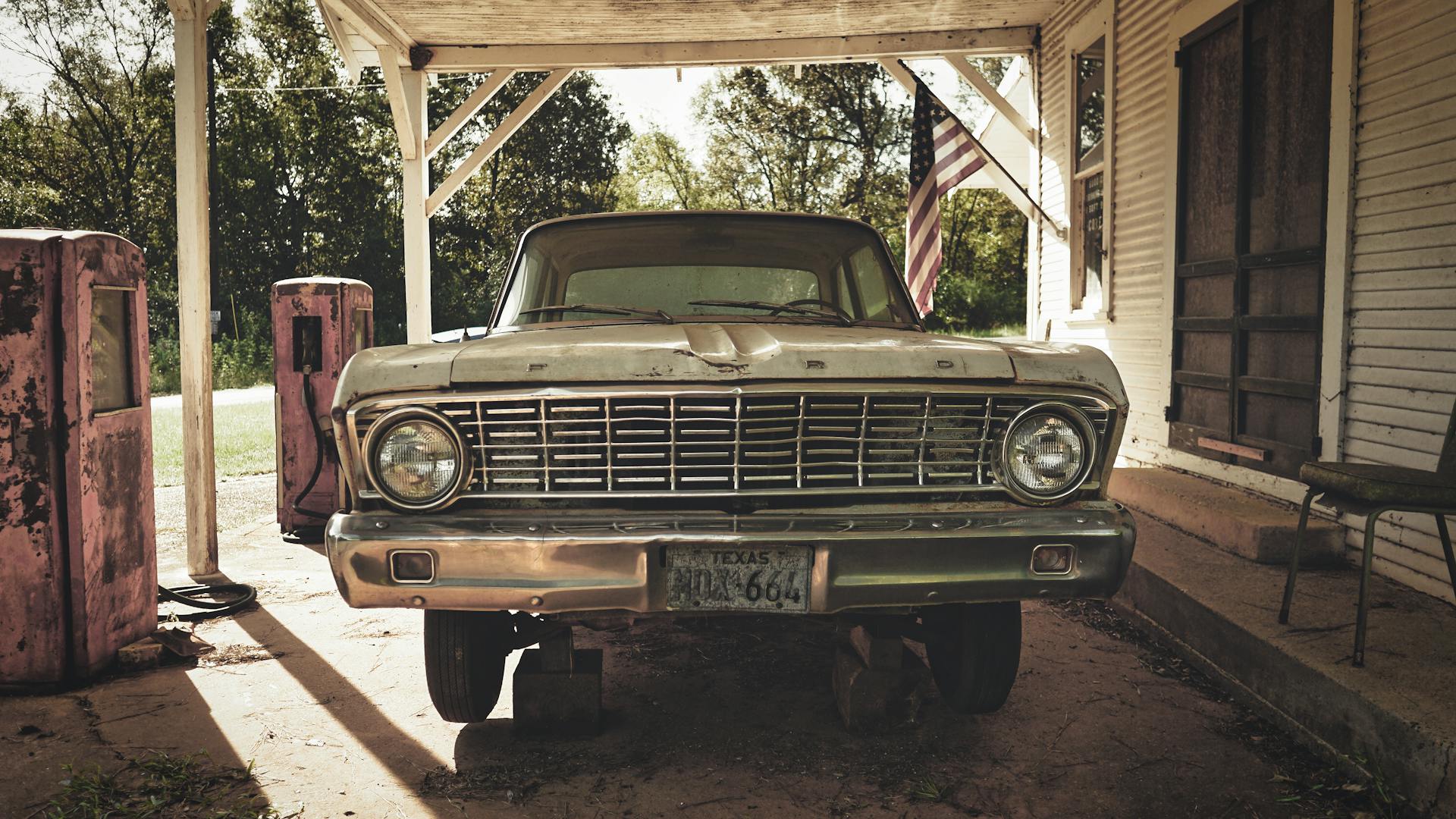 Classic Ford car parked at old gas station in San Augustine, Texas, USA. Retro Americana vibes.