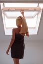 Woman in Yellow Scarf Standing Near Window