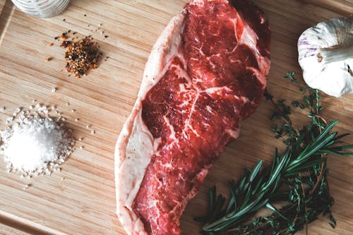 Raw Meat on Brown Wooden Chopping Board