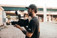 Man in Black T-shirt Holding Black Dslr Camera