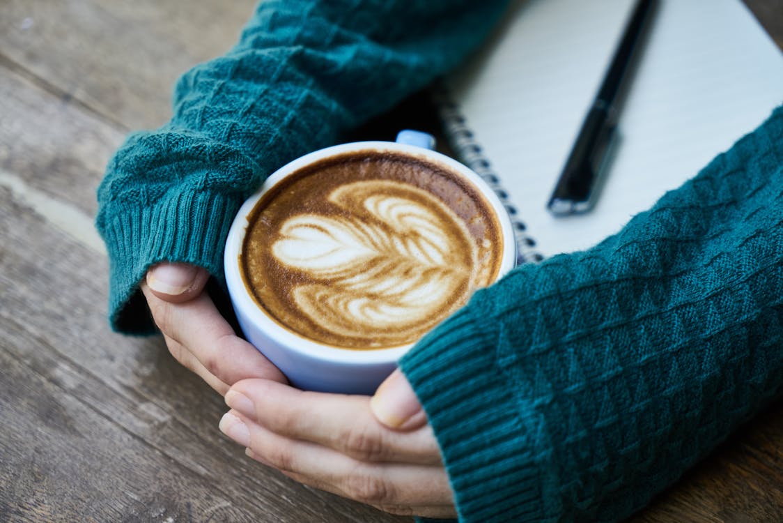 Free Person Touching Mug With Latte Art Stock Photo