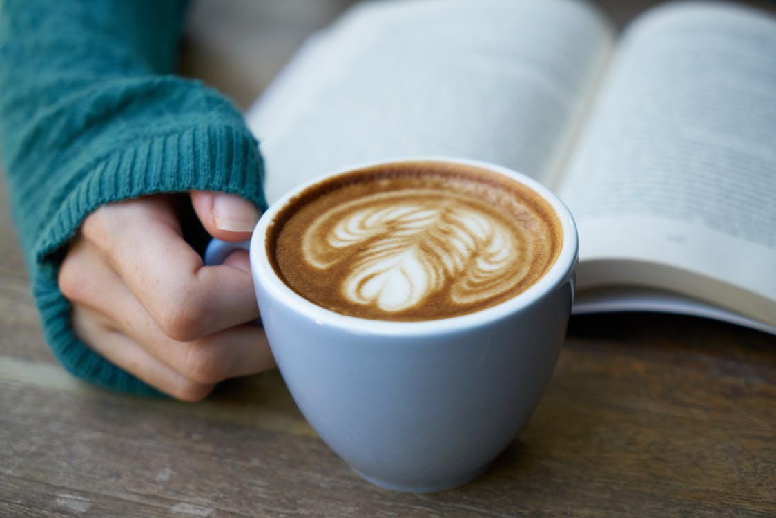 Free Person Holding Mug of Coffee Latte Stock Photo