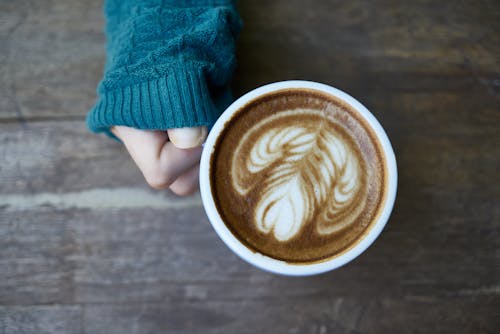 Person Holding Cup of Latte