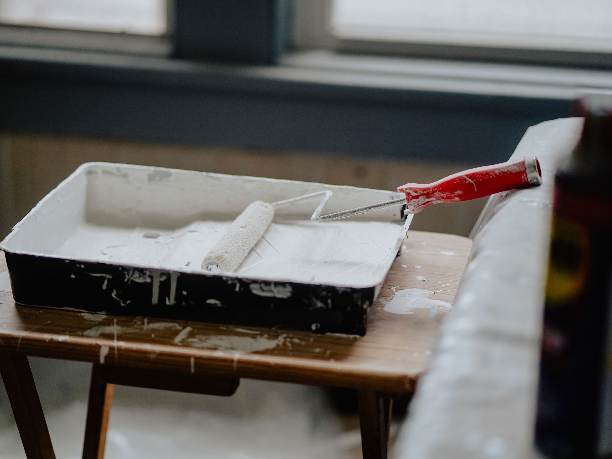 Painters & Decorators in Bullsmoor, London — professional decorator painting a wall with a roller
