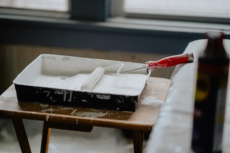 Paint roller and tray on a table — illustrating home renovation