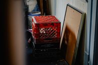 Stacked red crates and frames in an industrial backroom setting.