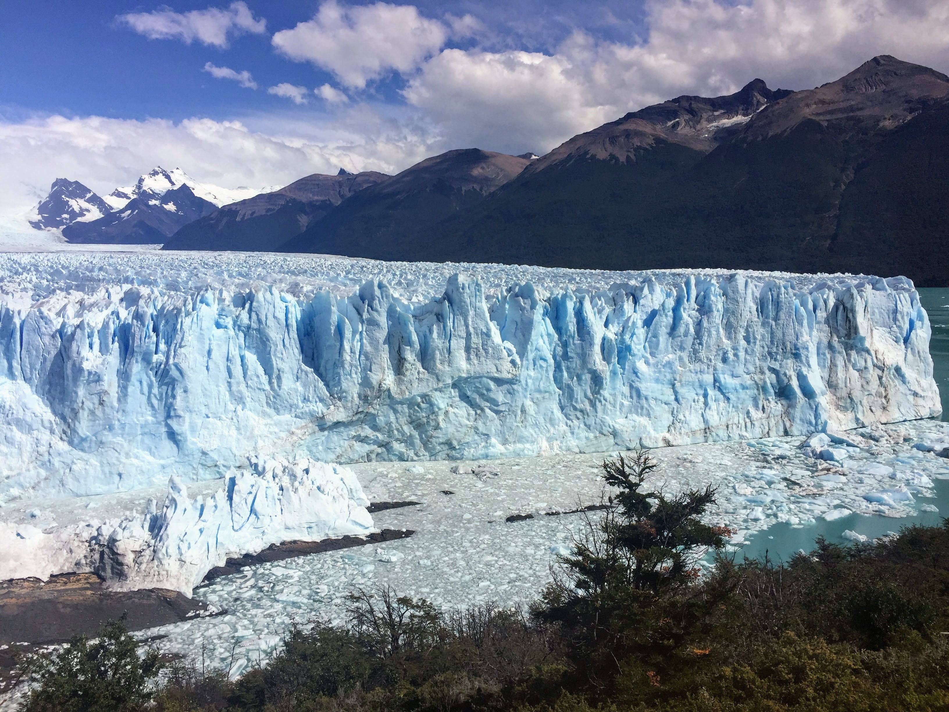 Majestic Perito Moreno Glacier under a vibrant sky, showcasing natural beauty and climate change impact. - El Calafate