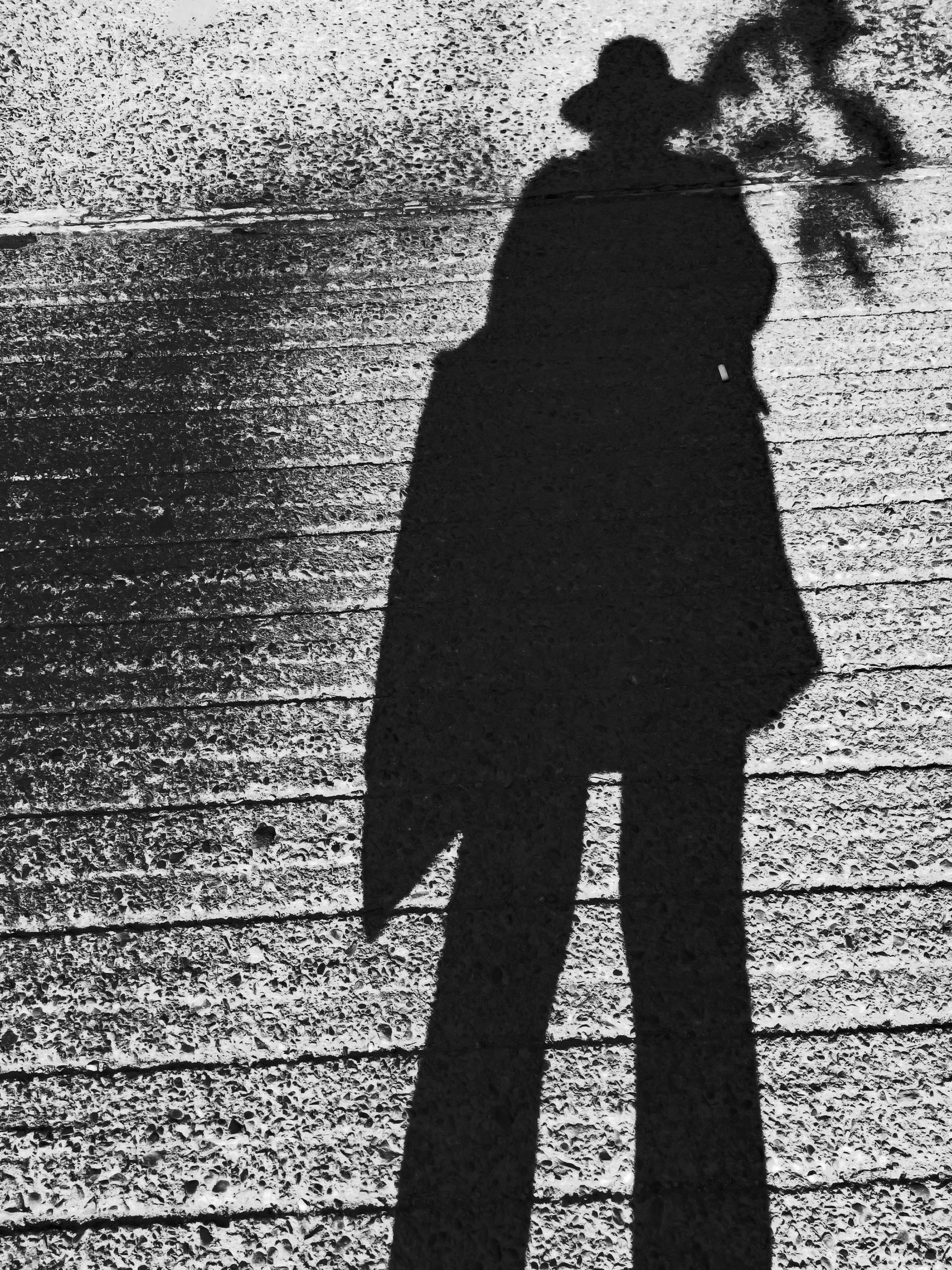 Person in Black Coat Standing on Gray Concrete Floor \u00b7 Free Stock Photo